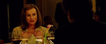 Movie still from “The Insider” (1999), directed by Michael Mann – A woman sitting at a dinner table with a man; Close Up shot, Over the shoulder angle