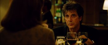 Movie still from “The Insider” (1999), directed by Michael Mann – A man and a woman sitting at a table with a glass of red wine; Close Up shot, Over the shoulder angle