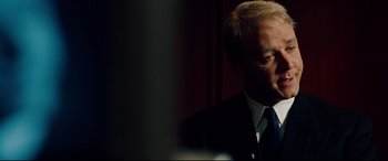 Movie still from “The Insider” (1999), directed by Michael Mann – A person wearing a suit and tie; Close Up shot, Over the shoulder angle