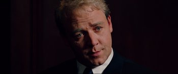 Movie still from “The Insider” (1999), directed by Michael Mann – A person wearing a suit and tie; Close Up shot, Low angle