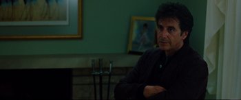 Movie still from “The Insider” (1999), directed by Michael Mann – A man sitting in front of a mirror in a room; Medium shot, Over the shoulder angle