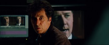 Movie still from “The Insider” (1999), directed by Michael Mann – A person in front of a tv; Close Up shot, Over the shoulder angle