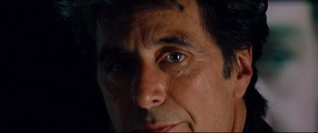 Movie still from “The Insider” (1999), directed by Michael Mann – A man's face with green eyes; Extreme Close Up shot, Low angle