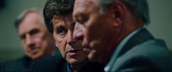 Movie still from “The Insider” (1999), directed by Michael Mann – Two older men looking at each other in a room; Close Up shot, Over the shoulder angle