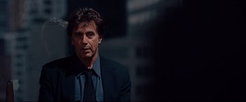 Movie still from “The Insider” (1999), directed by Michael Mann – A person wearing a suit and tie; Close Up shot, Over the shoulder angle