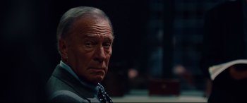 Movie still from “The Insider” (1999), directed by Michael Mann – An older man wearing a neck tie looking at the camera; Close Up shot, Low angle