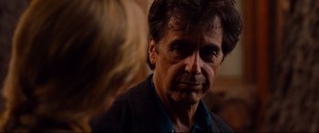 Movie still from “The Insider” (1999), directed by Michael Mann – An older man is looking at the camera; Close Up shot, Over the shoulder angle