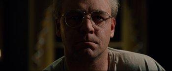 Movie still from “The Insider” (1999), directed by Michael Mann – A person wearing glasses; Close Up shot, Low angle