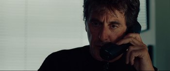 Movie still from “The Insider” (1999), directed by Michael Mann – A person talking on a phone; Close Up shot, Over the shoulder angle