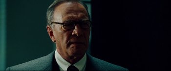 Movie still from “The Insider” (1999), directed by Michael Mann – An older man wearing a suit and tie; Close Up shot, Low angle