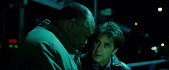 Movie still from “The Insider” (1999), directed by Michael Mann – Two men talking to each other in the dark; Close Up shot, Over the shoulder angle