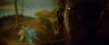 Movie still from “The Insider” (1999), directed by Michael Mann – A person wearing glasses; Extreme Close Up shot, Low angle