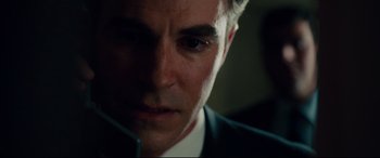 Movie still from “The Insider” (1999), directed by Michael Mann – A person wearing a suit and tie; Close Up shot, Over the shoulder angle
