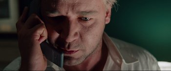 Movie still from “The Insider” (1999), directed by Michael Mann – A person holding a cell phone; Close Up shot, Low angle