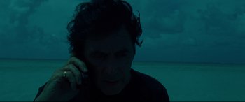 Movie still from “The Insider” (1999), directed by Michael Mann – A man on a cell phone in front of a body of water at night; Close Up shot, High angle