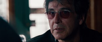 Movie still from “The Insider” (1999), directed by Michael Mann – A person wearing glasses; Close Up shot, Over the shoulder angle