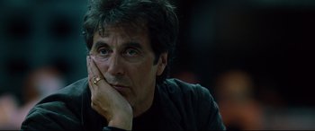 Movie still from “The Insider” (1999), directed by Michael Mann – A person with his hand under his chin; Close Up shot, Over the shoulder angle