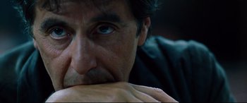 Movie still from “The Insider” (1999), directed by Michael Mann – A man's face with his hand on his chest; Extreme Close Up shot, Over the shoulder angle