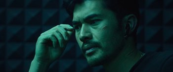 A man's face in a dark room