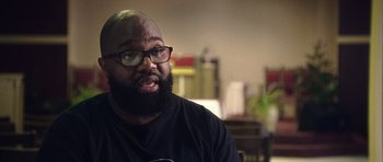 A man with a goatee wearing glasses and a black shirt