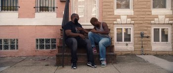 A couple of men sitting next to each other on steps