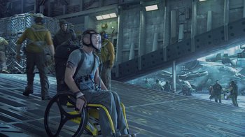 Movie still from “Avatar” (2009), directed by James Cameron – A man sitting in a wheel chair on top of an airplane; Wide shot, High angle