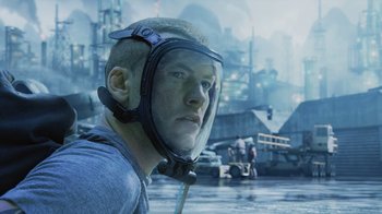 Movie still from “Avatar” (2009), directed by James Cameron – A man with a helmet on his head is standing in front of some water; Close Up shot, Low angle