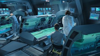 Movie still from “Avatar” (2009), directed by James Cameron – A group of people in a room with a computer screen; Wide shot, High angle