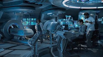 Movie still from “Avatar” (2009), directed by James Cameron – Two people in a room with a lot of computer screens; Wide shot, High angle