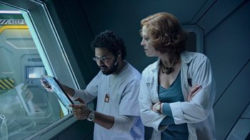 Movie still from “Avatar” (2009), directed by James Cameron – A man and a woman in lab coats looking at a computer screen; Medium shot, Low angle