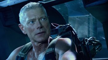 Movie still from “Avatar” (2009), directed by James Cameron – A person with a gun in his hand; Close Up shot, Over the shoulder angle