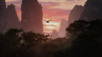 Movie still from “Avatar” (2009), directed by James Cameron – A bird flying in the air over a mountain range at sunset; Extreme Wide shot, Low angle