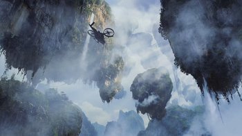 Movie still from “Avatar” (2009), directed by James Cameron – A mountain bike flying through the air above some mountains; Extreme Wide shot, Overhead angle