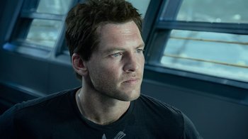 Movie still from “Avatar” (2009), directed by James Cameron – A person wearing a black t - shirt; Close Up shot, Low angle