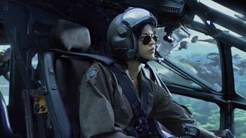 Movie still from “Avatar” (2009), directed by James Cameron – A person in a helicopter wearing a helmet and goggles; Medium shot, Low angle