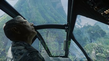 Movie still from “Avatar” (2009), directed by James Cameron – A man looking out the window of a helicopter; Close Up shot, Over the shoulder angle