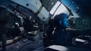 Movie still from “Avatar” (2009), directed by James Cameron – A man in a helicopter cockpit wearing a helmet; Wide shot, High angle