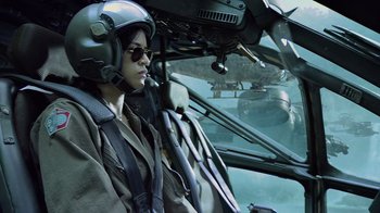 Movie still from “Avatar” (2009), directed by James Cameron – A person in a helicopter cockpit wearing a helmet; Medium shot, Low angle