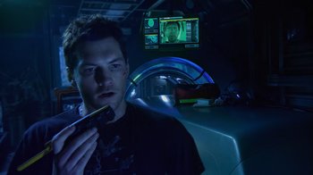 Movie still from “Avatar” (2009), directed by James Cameron – A man holding a remote control in his hand; Close Up shot, Over the shoulder angle