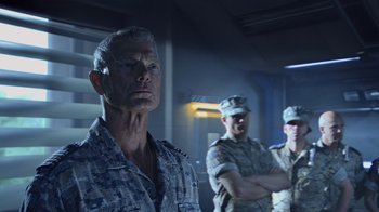 Movie still from “Avatar” (2009), directed by James Cameron – A group of men standing next to each other in a room; Close Up shot, Low angle