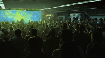 Movie still from “Avatar” (2009), directed by James Cameron – A large group of people watching a large screen television; Extreme Wide shot, High angle