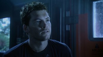 Movie still from “Avatar” (2009), directed by James Cameron – A person wearing a black t - shirt; Close Up shot, Low angle