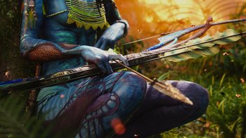 Movie still from “Avatar” (2009), directed by James Cameron – A person with body paint holding a bow and arrow; Extreme Close Up shot, High angle