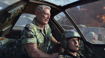 Movie still from “Avatar” (2009), directed by James Cameron – An older man and a younger man are in a helicopter cockpit; Medium shot, Low angle
