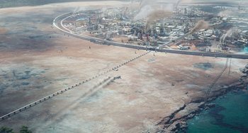 Movie still from “Avatar: The Way of Water” (2022), directed by James Cameron – An aerial view of an oil refinery and a highway; Extreme Wide shot, High angle
