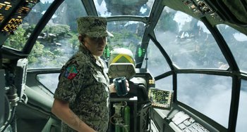 Movie still from “Avatar: The Way of Water” (2022), directed by James Cameron – A man in a military uniform is holding a camera; Medium shot, Over the shoulder angle