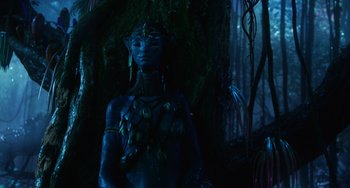 Movie still from “Avatar: The Way of Water” (2022), directed by James Cameron – A statue of an elf in a dark forest; Medium shot, Low angle