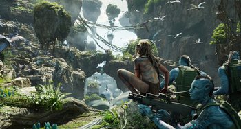 Movie still from “Avatar: The Way of Water” (2022), directed by James Cameron – A woman sitting on top of a tree in the middle of a jungle; Extreme Wide shot, Low angle