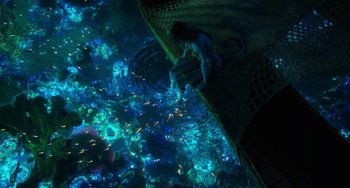 Movie still from “Avatar: The Way of Water” (2022), directed by James Cameron – An underwater view of a person swimming in a pool; Wide shot, Overhead angle
