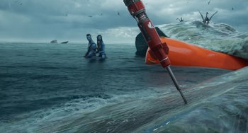 Movie still from “Avatar: The Way of Water” (2022), directed by James Cameron – Two people in the water with a surfboard; Extreme Wide shot, High angle